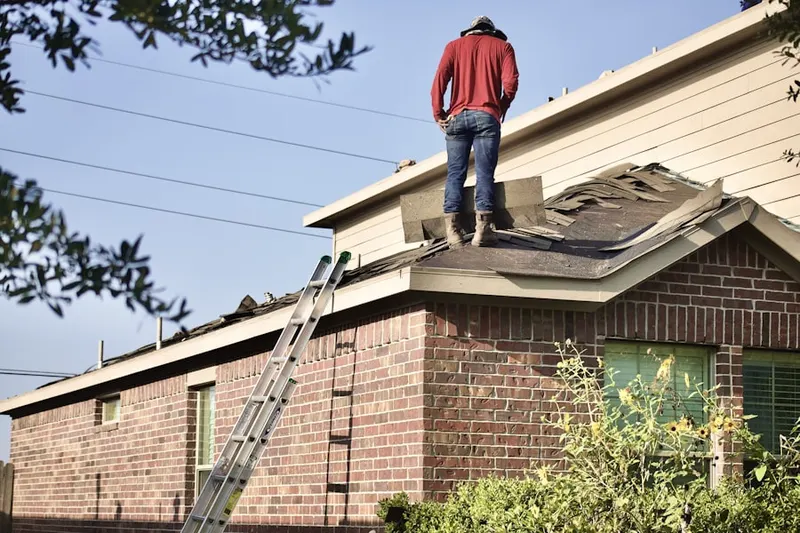 Professional roofer working on a residential roof in Dallas